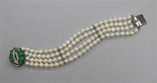 A modern multi strand cultured pearl bracelet with 14 ct white gold and jadeite clasp, 18 cm approx.